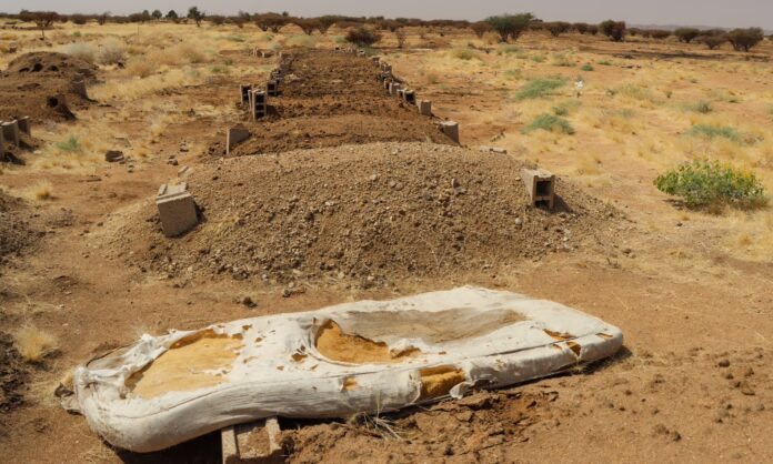A bloodied mattress lies next to mass graves at the site. Photograph: Mark Townsend/The Guardian