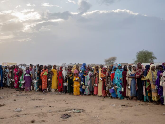 A crowd of Sudanese refugees from the Darfur who were waiting to receive food at an impromptu aid distribution centre on the outskirts of a refugee camp in Adre, Chad, last month. Photograph: Photograph: Ivor Prickett/The New York Times